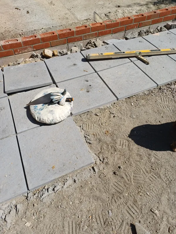 Paving slabs laid up to new brickwork