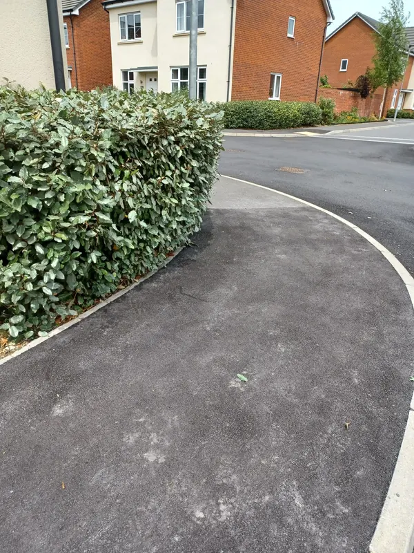 Hedge trimmed back off the footpath at a new-build home