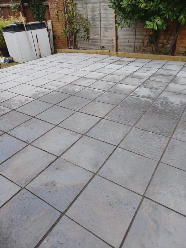 Finished grey slab patio in a back garden